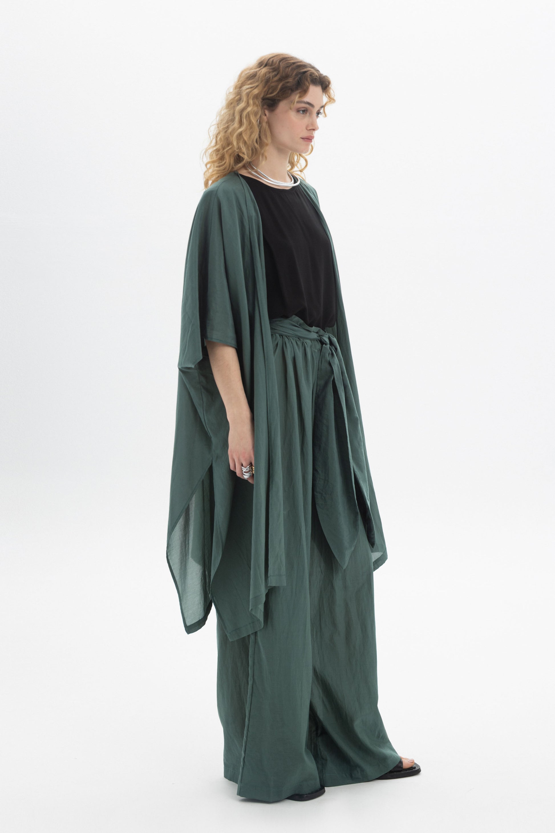 Model wearing a lightweight Sheer Kimono with wide sleeves, styled over a black top and loose pants.
