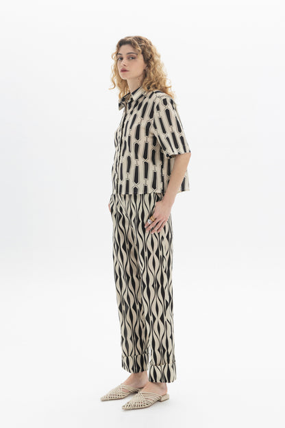 Model wearing Abstract Straight Trousers with an abstract print and an elastic waistband for a stylish look.