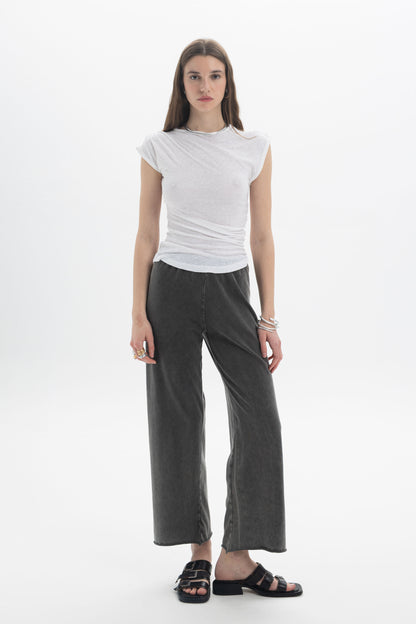 B&B x F Draped Cap Sleeve Top worn with wide-leg pants, showcasing a modern and effortless style.