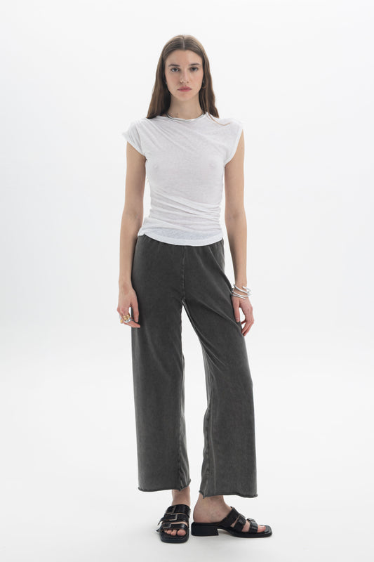 B&B x F Draped Cap Sleeve Top worn with wide-leg pants, showcasing a modern and effortless style.