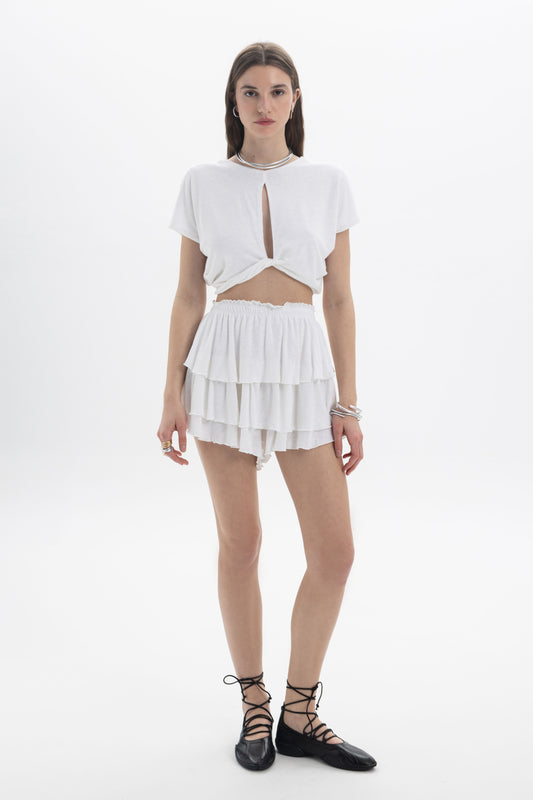 B&B x F Layered Ruffle Shorts showcased with a stylish white top and black lace-up shoes, perfect for warm weather.