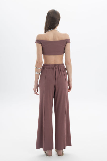 Model wearing the B&B x F Off-Shoulder Crop Top with high-waisted pants, showcasing a modern and minimal look.