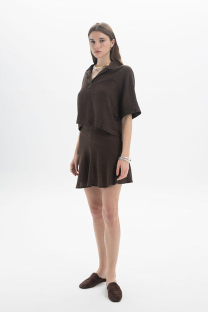 Model wearing a Linen Polo Top with matching skirt, showcasing a relaxed silhouette and casual summer style.
