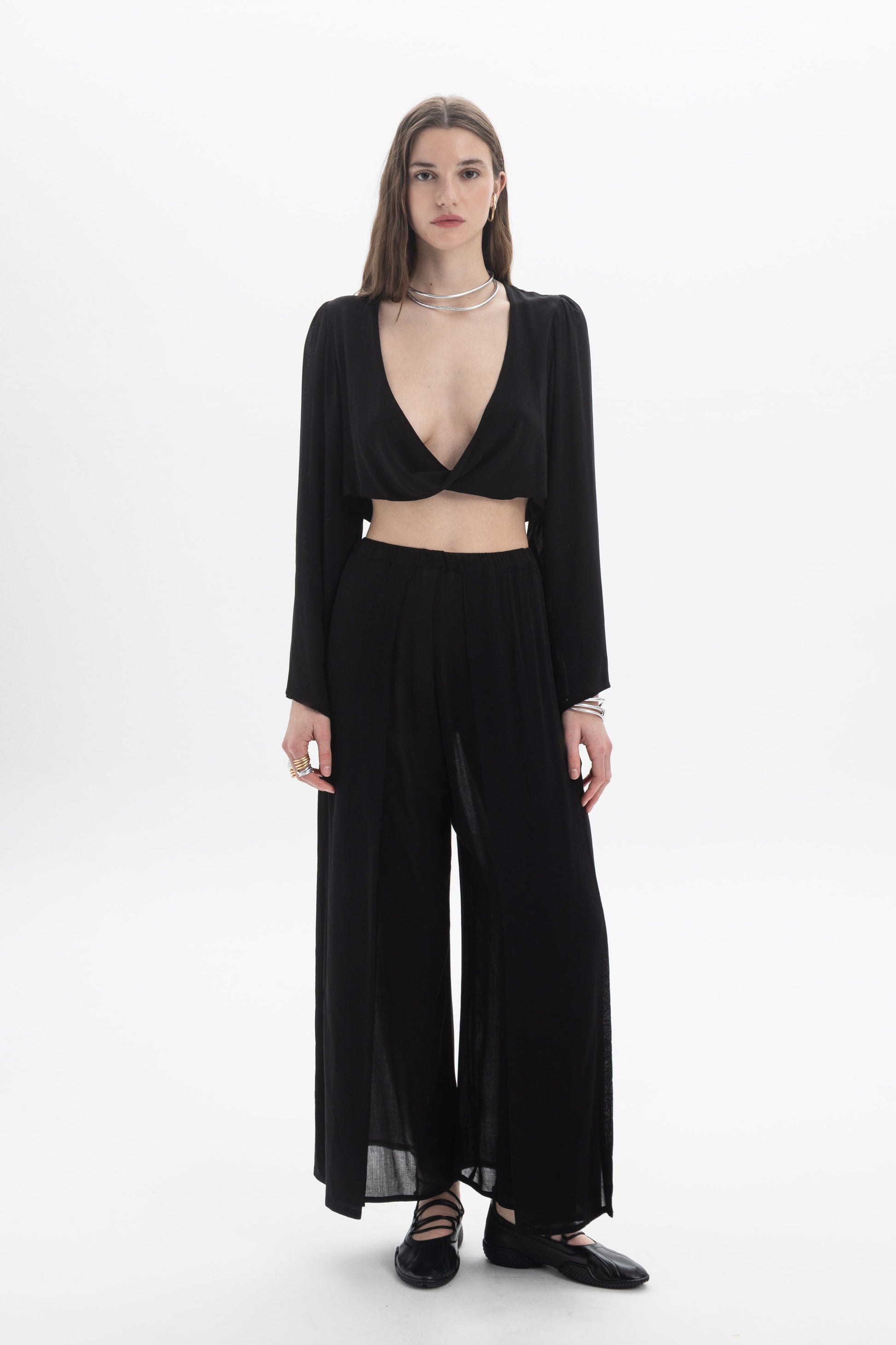 Model wearing Wide Leg Sheer Pants paired with a stylish crop top against a minimalist background.