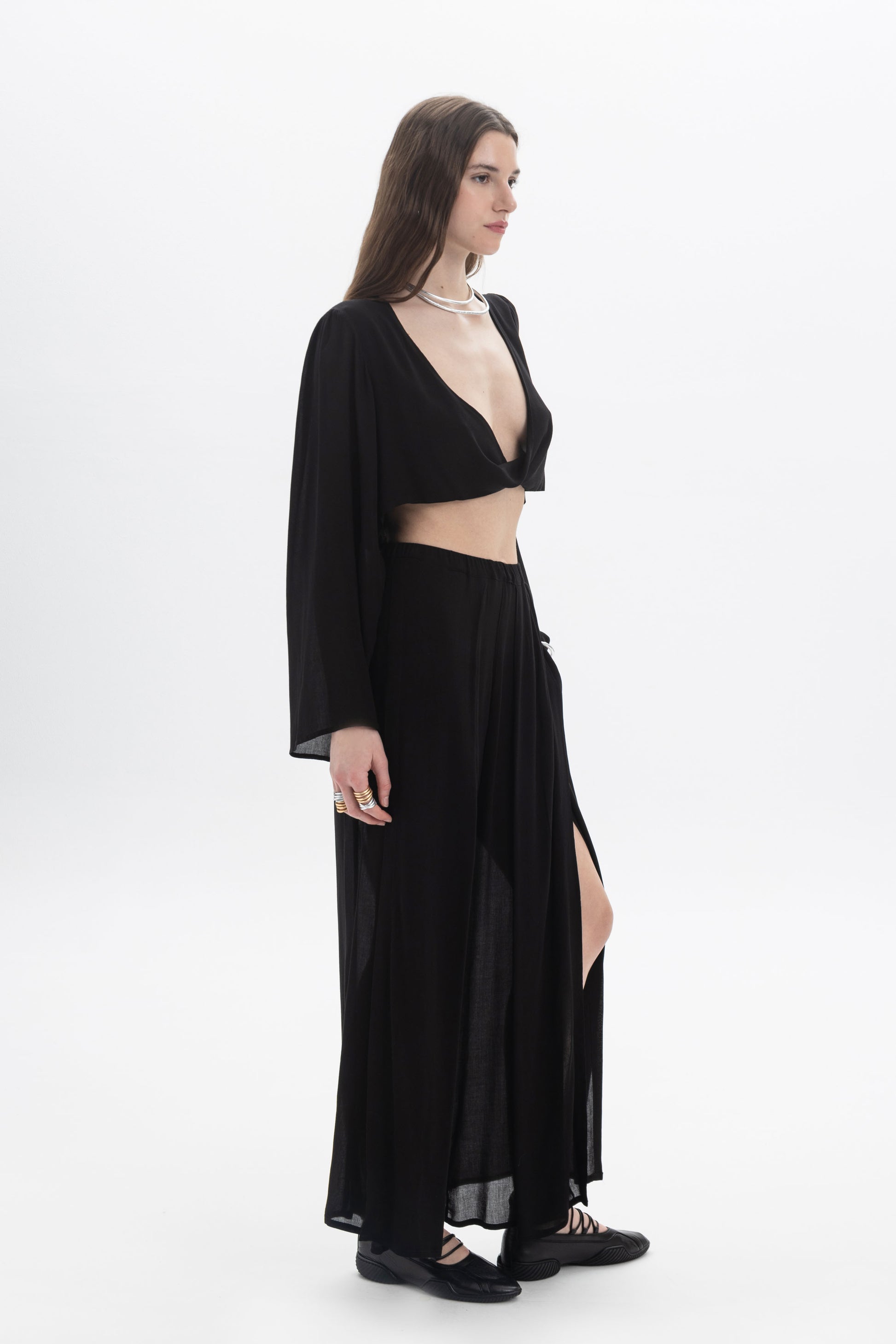 Model wearing Wide Leg Sheer Pants with a cropped top, showcasing the relaxed fit and semi-sheer fabric.