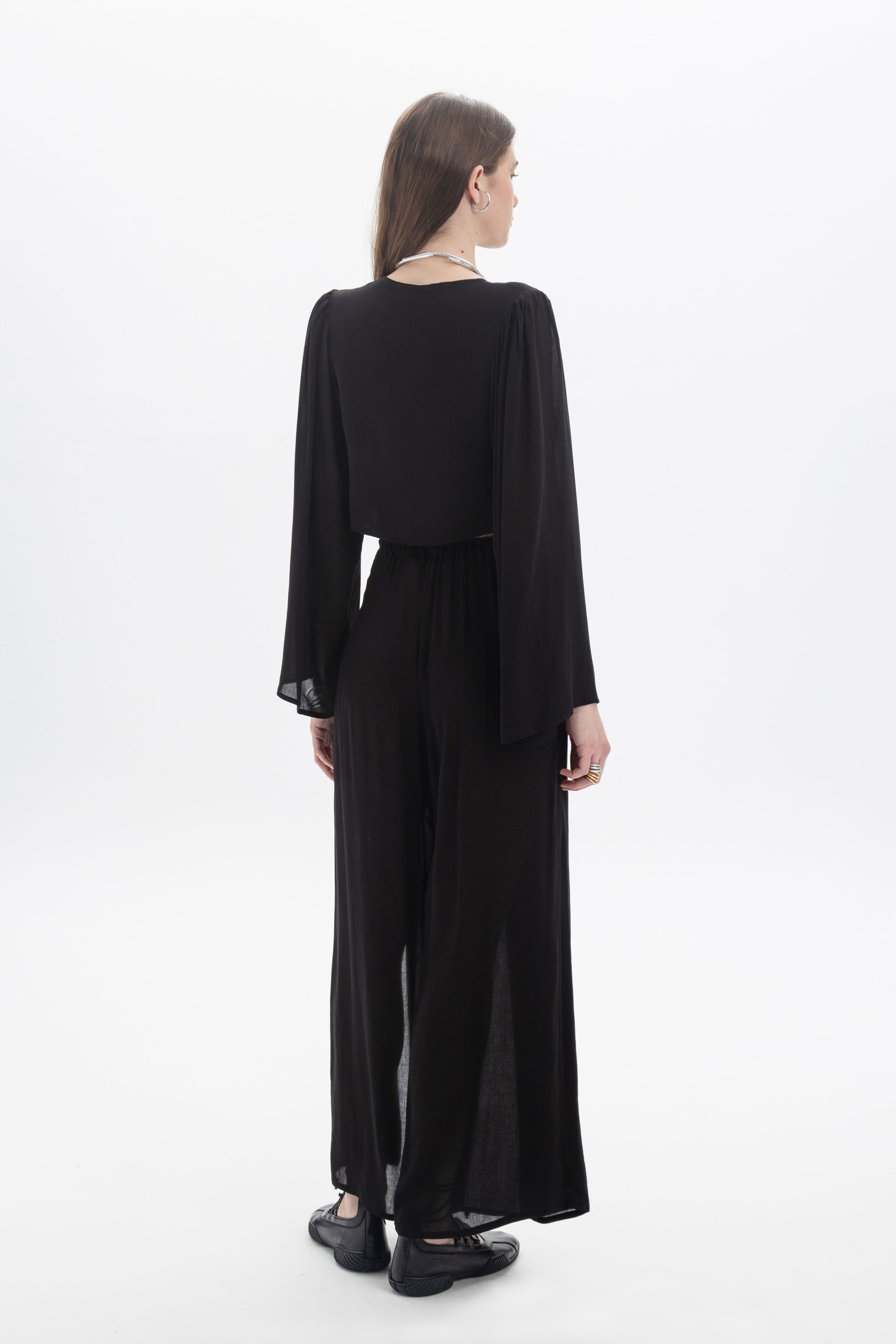 Wide Leg Sheer Pants displayed from the back, featuring a relaxed silhouette and lightweight fabric for comfort.