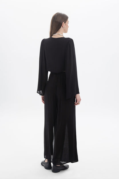 Wide Leg Sheer Pants displayed from the back, featuring a relaxed silhouette and lightweight fabric for comfort.