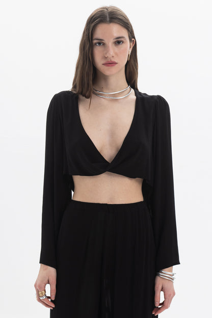 Draped Cropped Long Sleeve Top in black with deep V neckline and fluid silhouette.