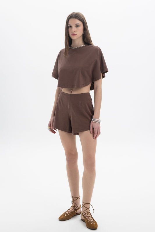 B&B x F Cropped Short Sleeve Top worn by a model, featuring a relaxed silhouette in a brown color.