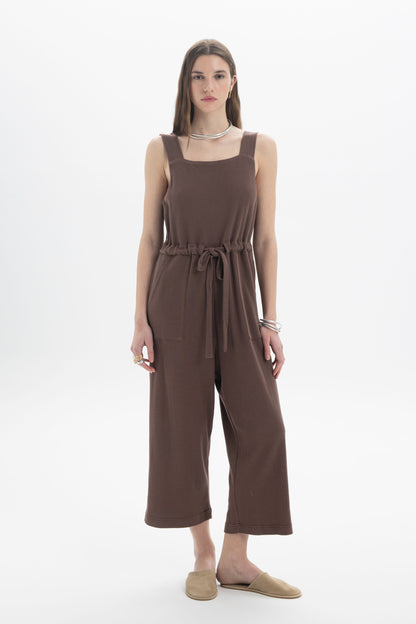 B&B x F Belted Jumpsuit featuring a square neckline, wide shoulder straps, and adjustable drawstring waist in brown.