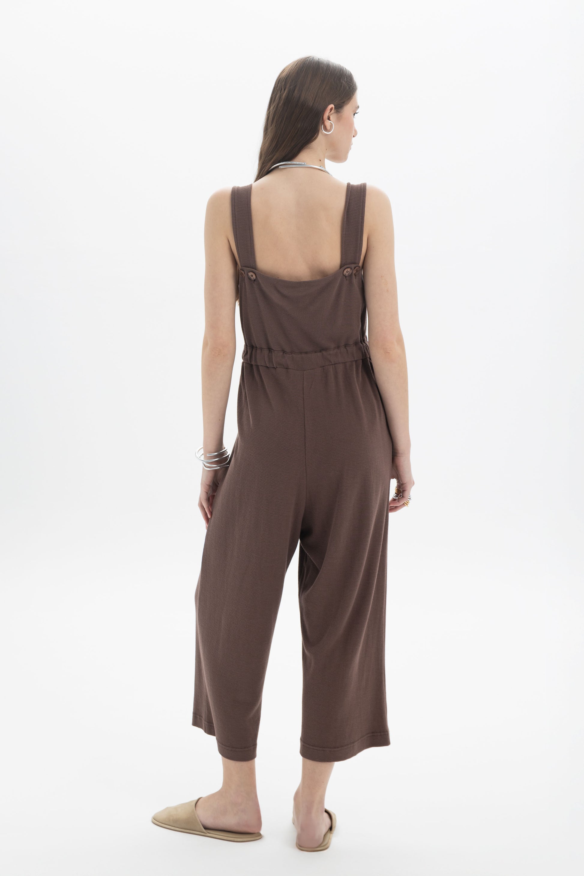 B&B x F Belted Jumpsuit shown from the back, featuring adjustable straps and relaxed fit in a brown fabric.