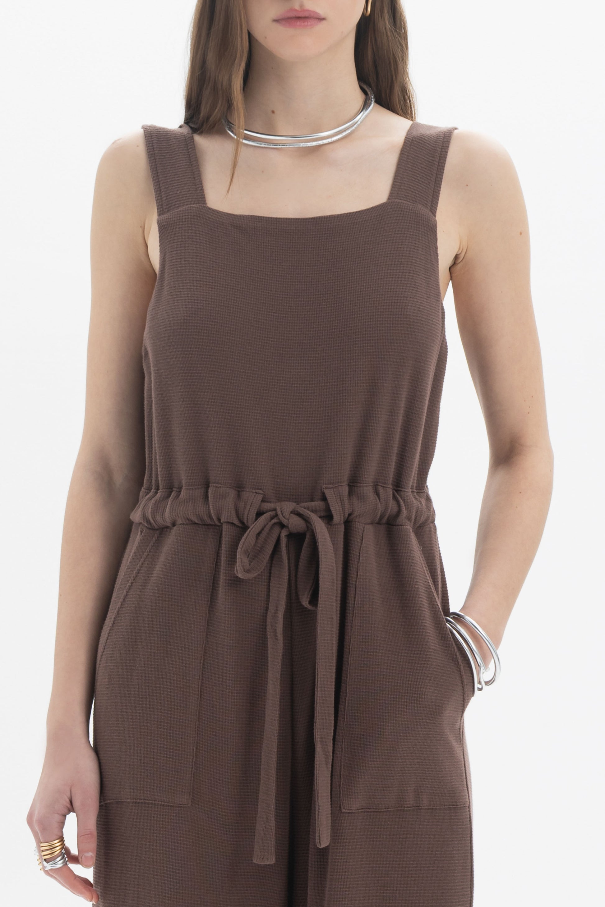 B&B x F Belted Jumpsuit in brown with square neckline and adjustable drawstring waist, featuring patch pockets.