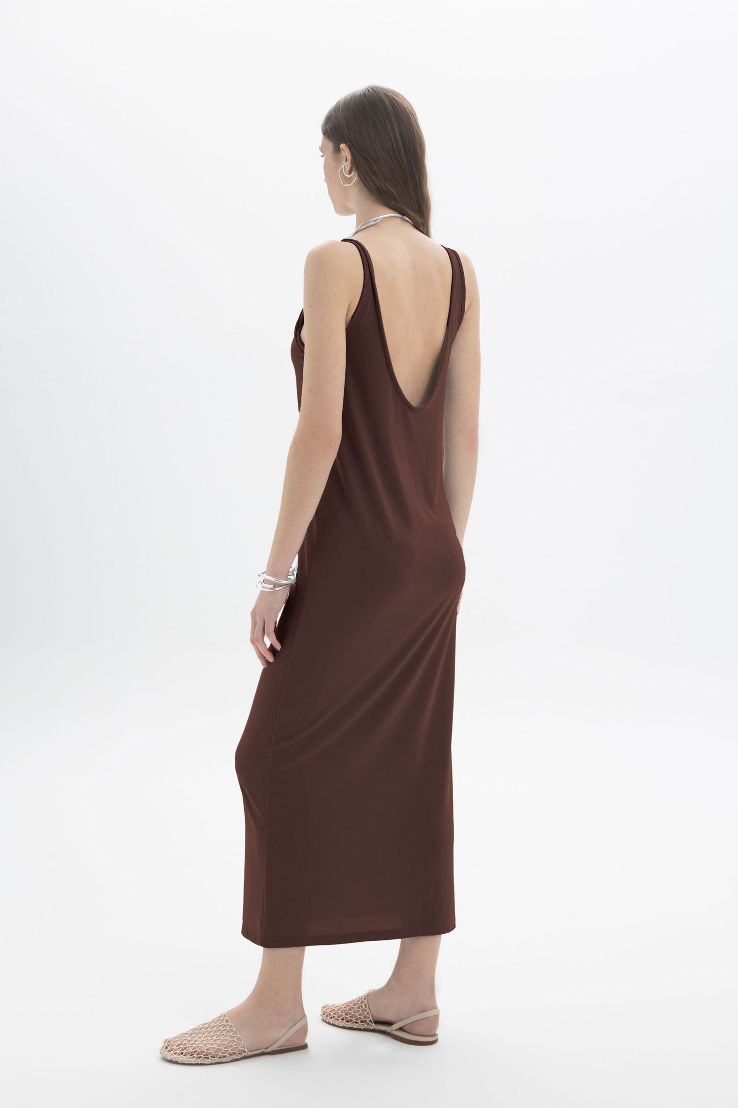 Black and Black open back tank dress displayed on a hanger, featuring a sleeveless design and stylish open back detail.