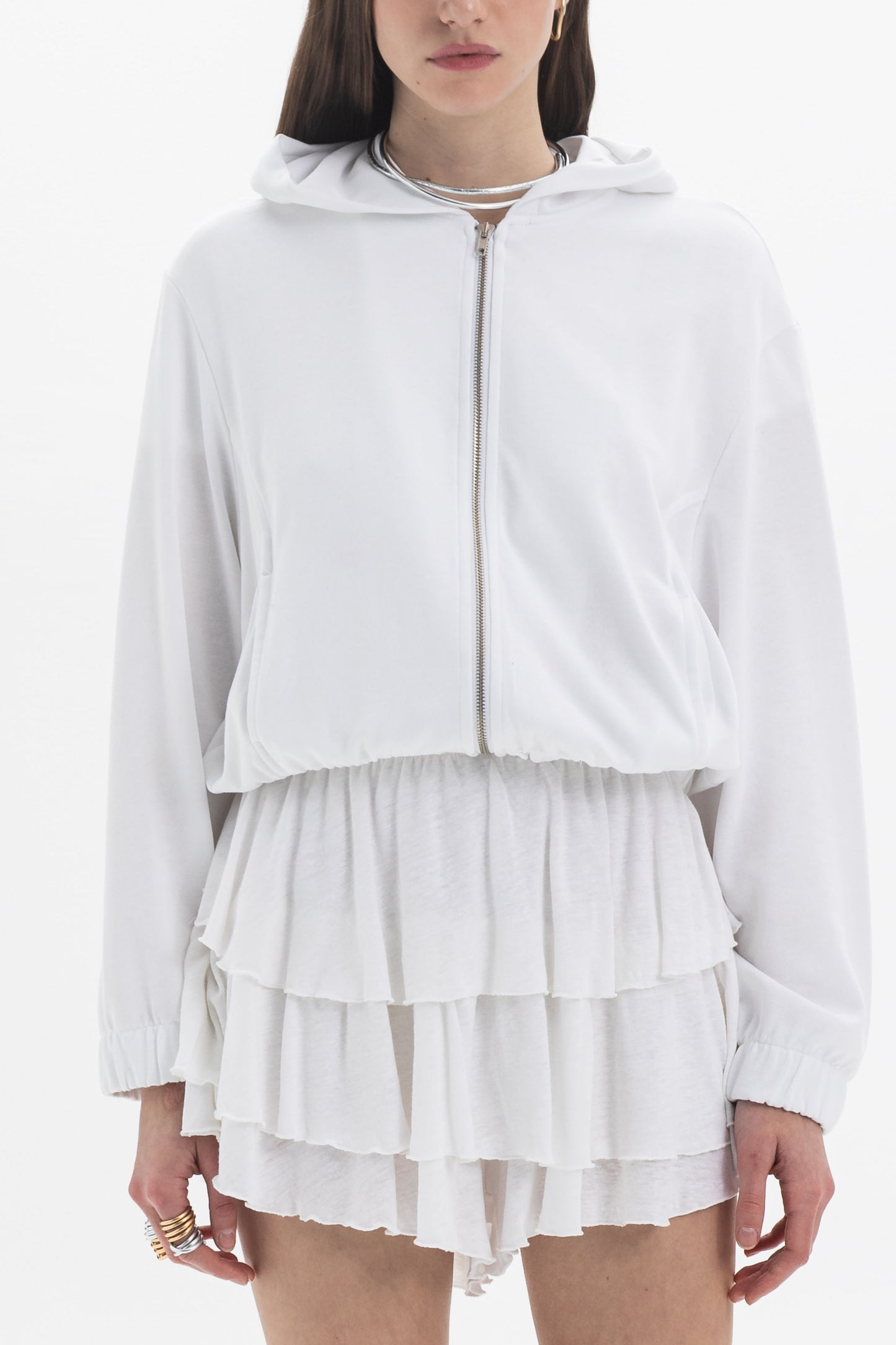 Model wearing B&B x F Layered Ruffle Shorts with a white zip-up hoodie, showcasing the playful ruffle design.