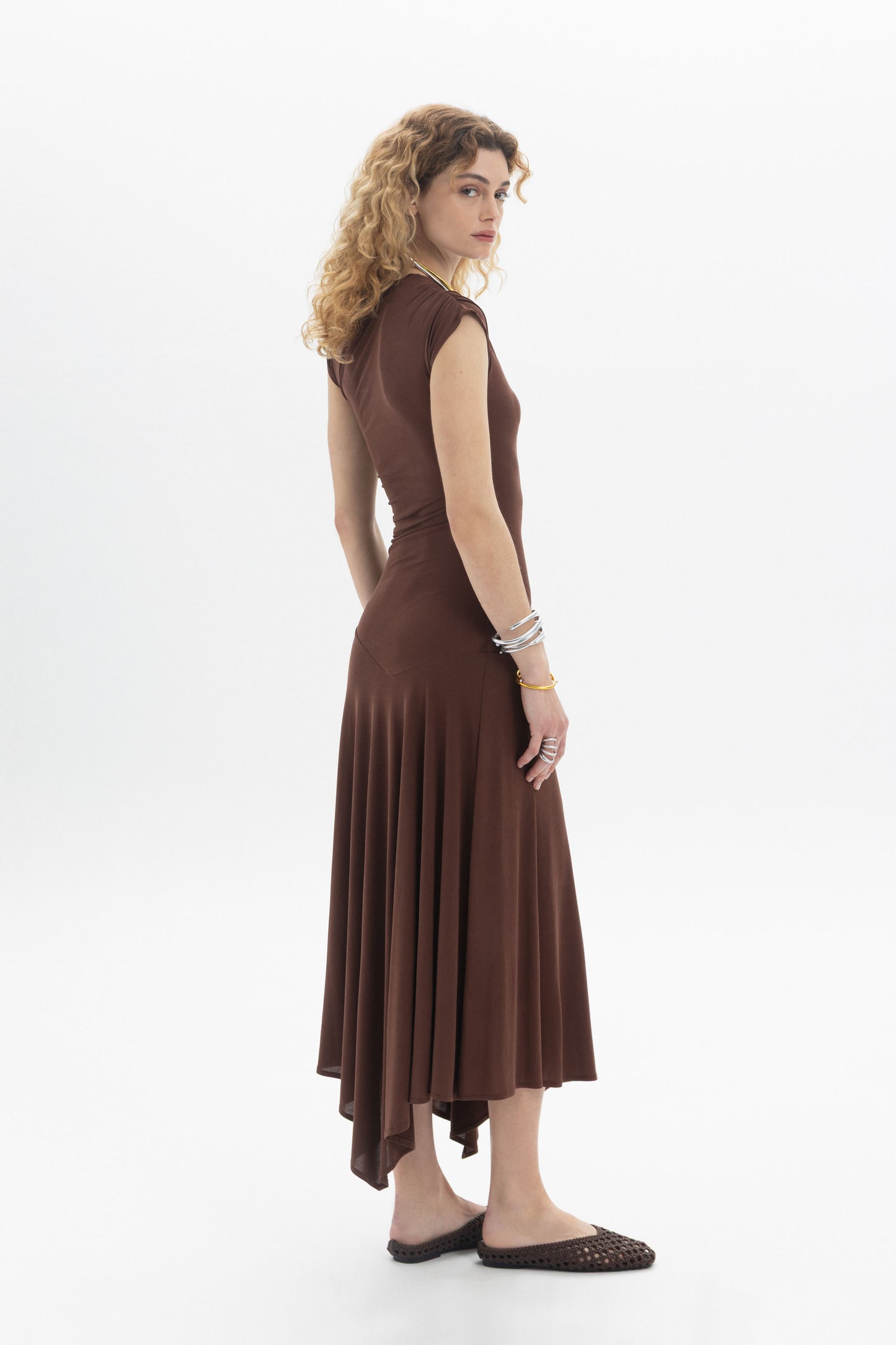 Model showing the Asymmetric Midi Dress with sleeveless design and a flowing asymmetric hem.