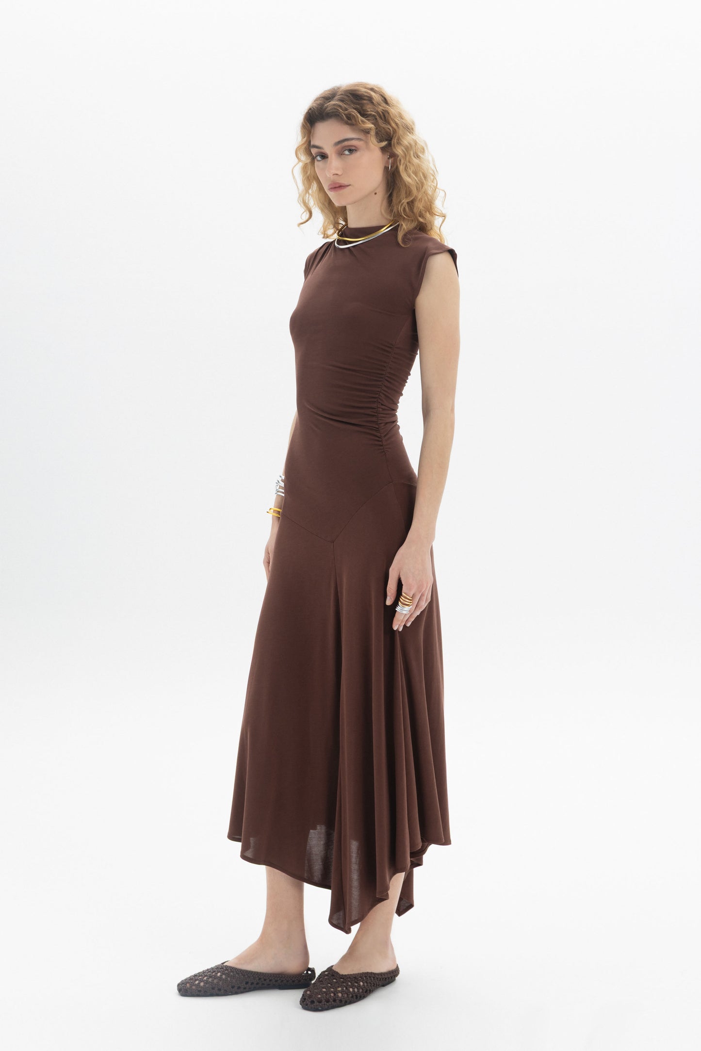 Asymmetric Midi Dress in brown with side ruching and flowing hem, elegant and feminine silhouette.