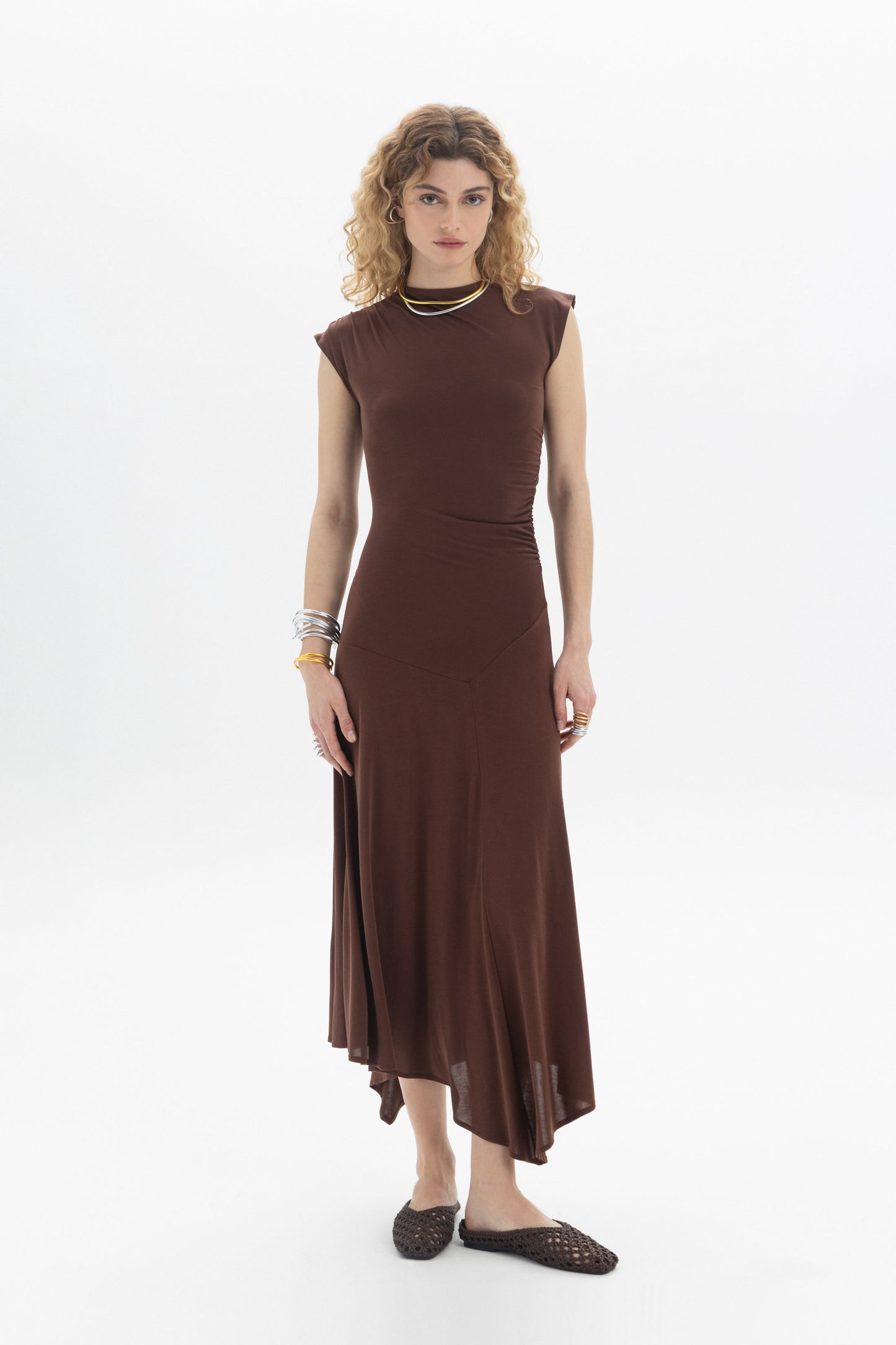 Asymmetric Midi Dress in brown with sleeveless design, side ruching, and flowing asymmetric hem.
