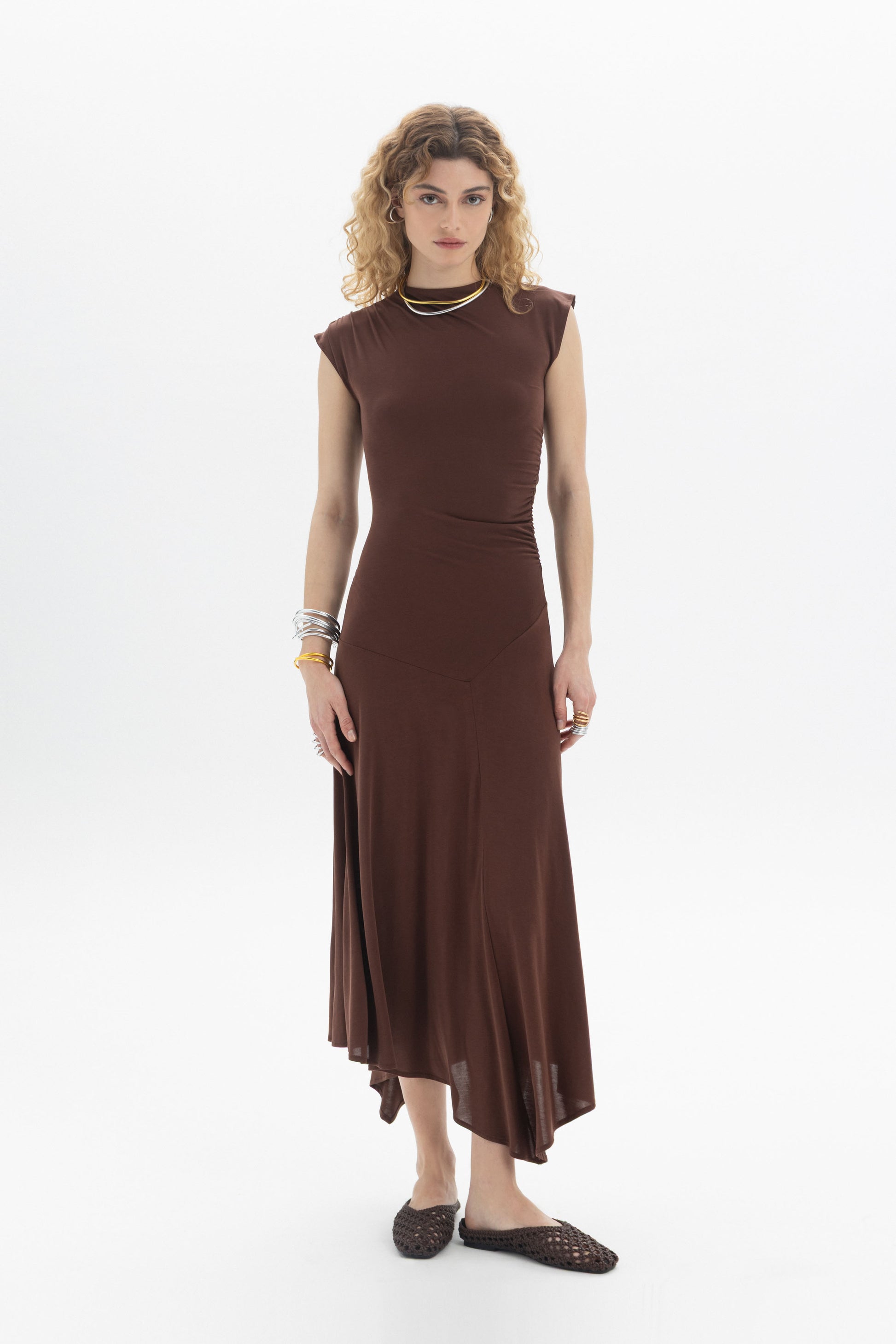 Asymmetric Midi Dress in brown with sleeveless design, side ruching, and flowing asymmetric hem.