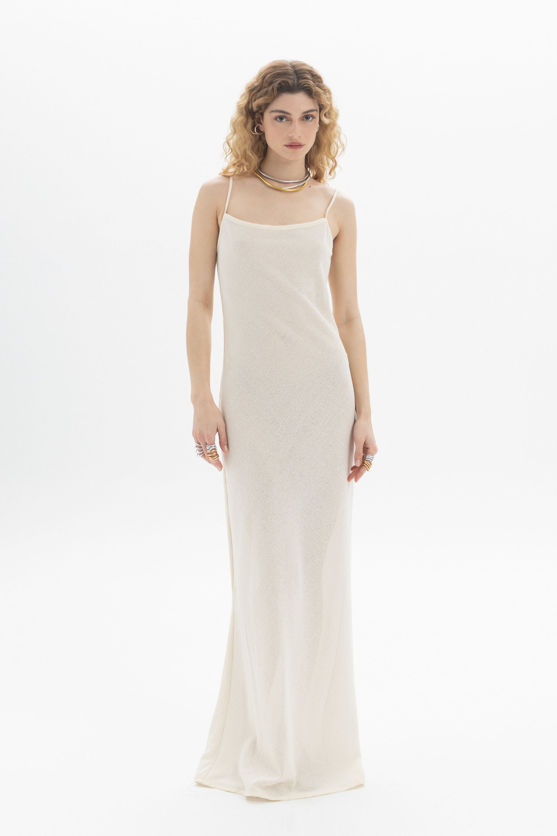 Elegant model wearing a Slip Maxi Dress with spaghetti straps and a slim straight fit, showcasing a refined feminine style.