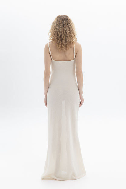 Back view of a woman wearing a Slip Maxi Dress with spaghetti straps and a slim straight fit.