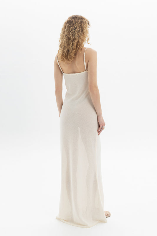 Back view of a model wearing a Slip Maxi Dress, featuring spaghetti straps and a fluid silhouette.