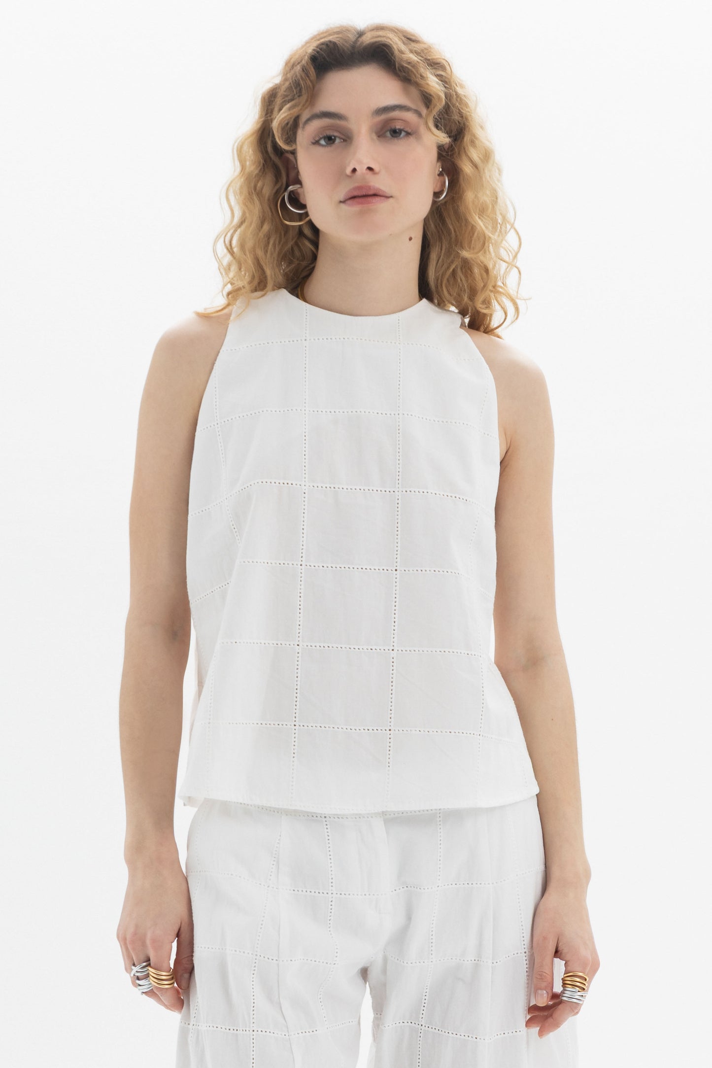 Sleeveless High-Neck Top featuring a clean design and textured detailing, styled in a relaxed fit.