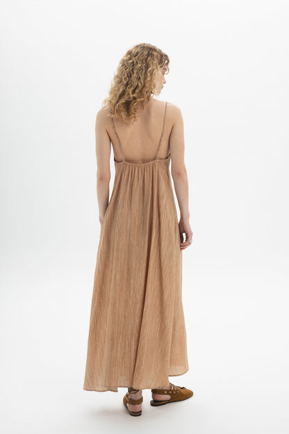 Back view of a woman wearing a Drawstring Maxi Dress with spaghetti straps in a soft fabric for a relaxed silhouette.