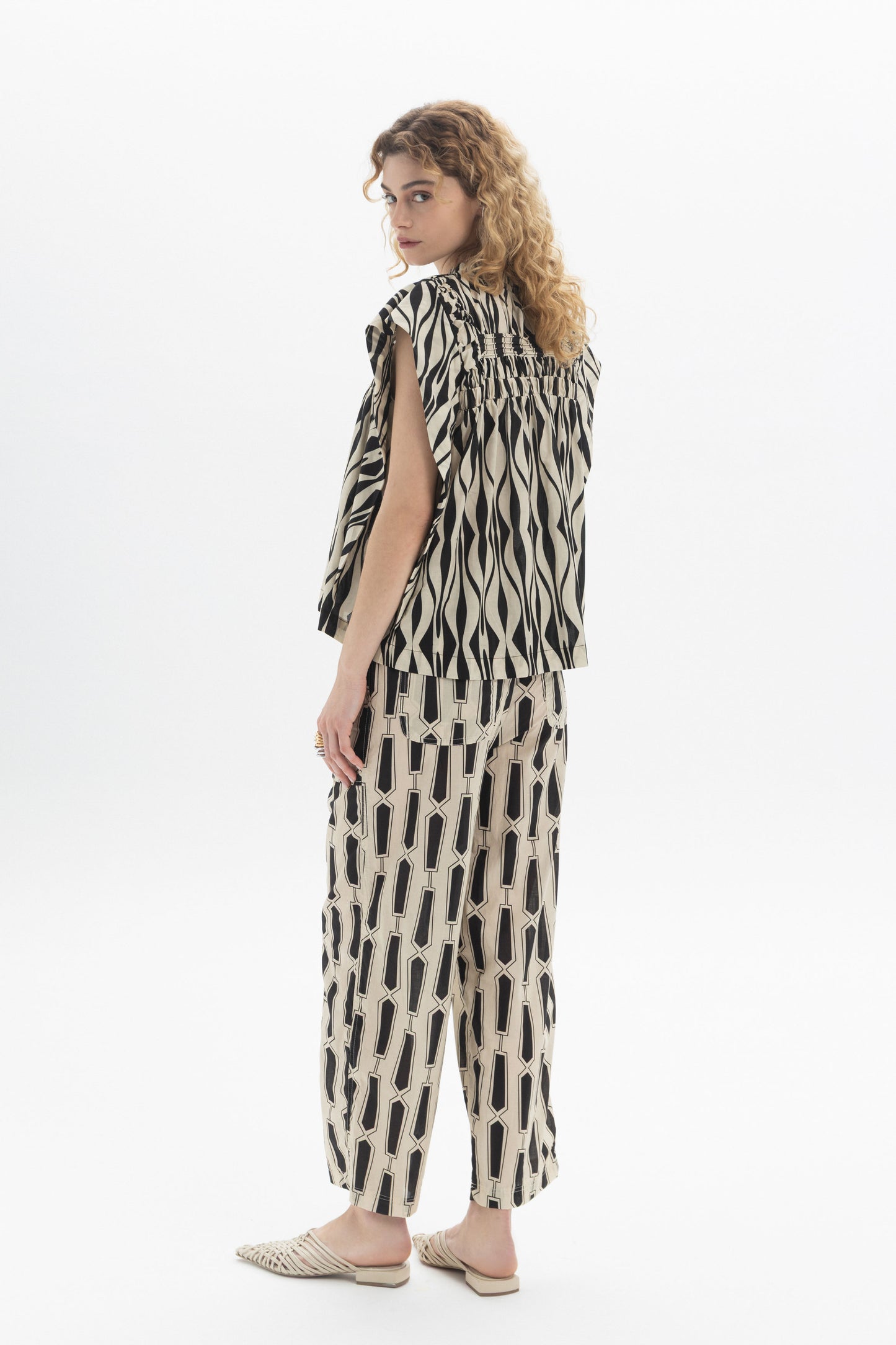 Gathered Sleeveless Top in a relaxed fit with gathered detailing, complemented by fashionable patterned pants.