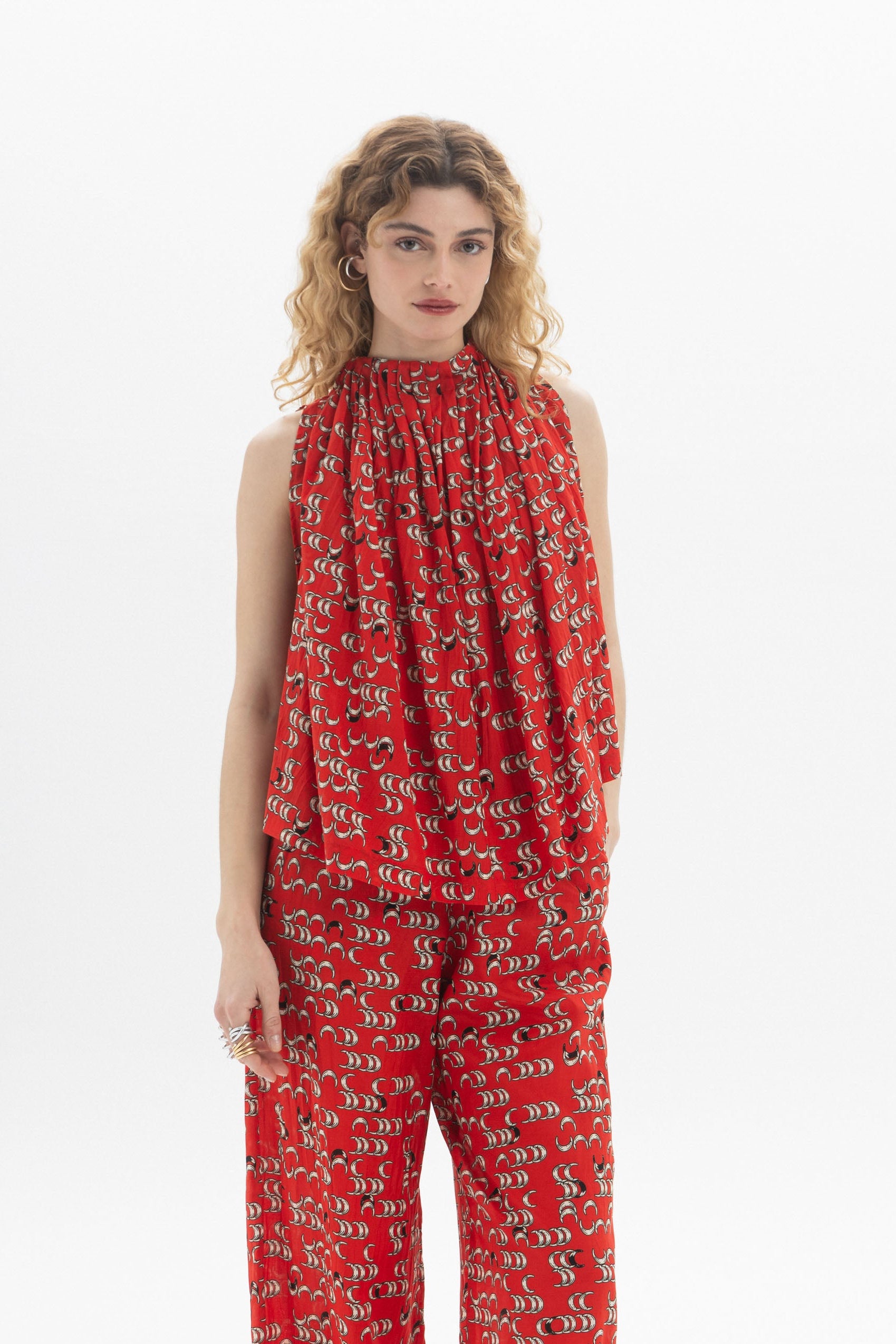 Draped High-Neck Top in red, sleeveless with gathered neckline and fluid drape for soft volume and movement.