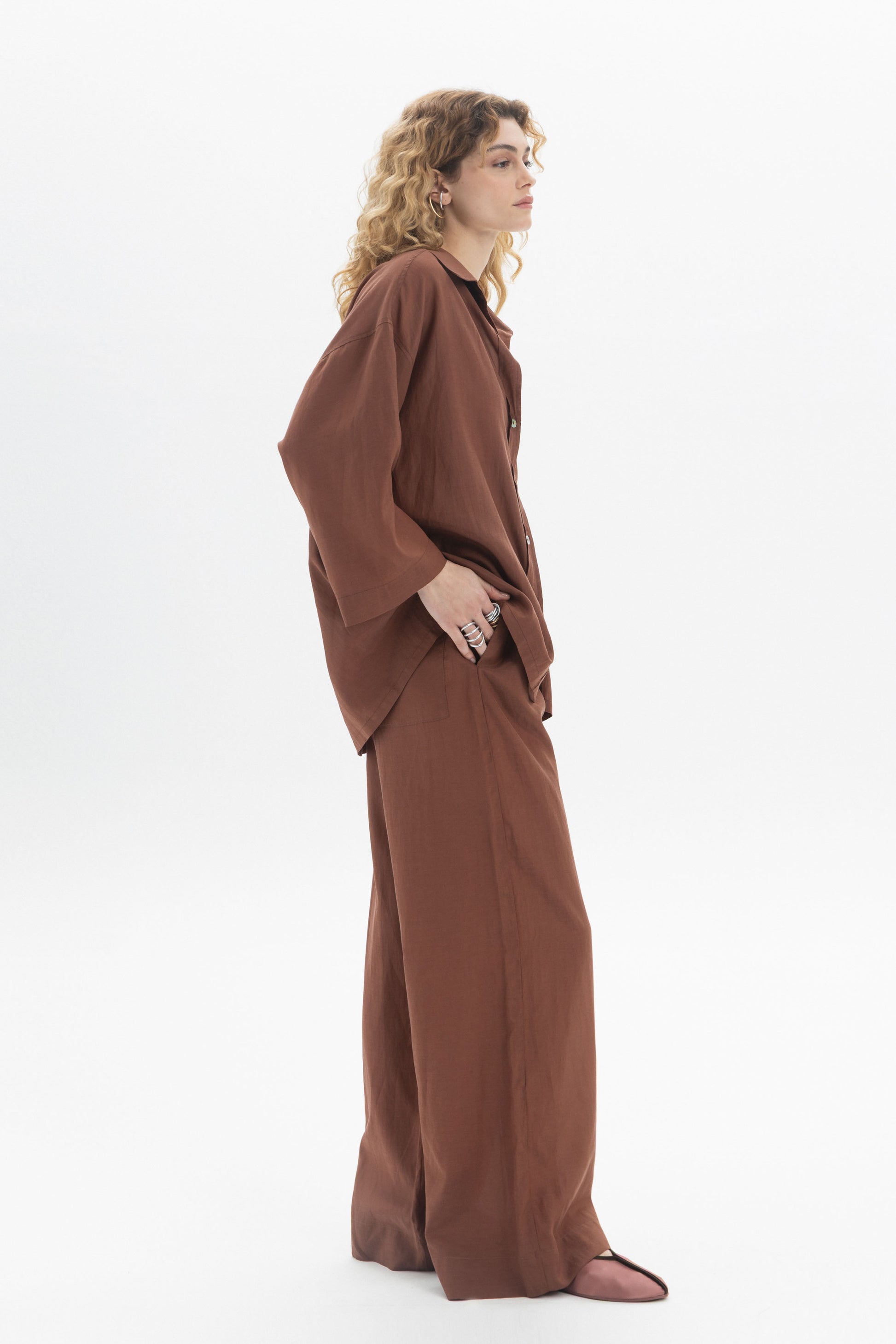 Relaxed Button-Up Shirt worn with matching trousers, featuring a soft collar and dropped shoulders for a laid-back look.