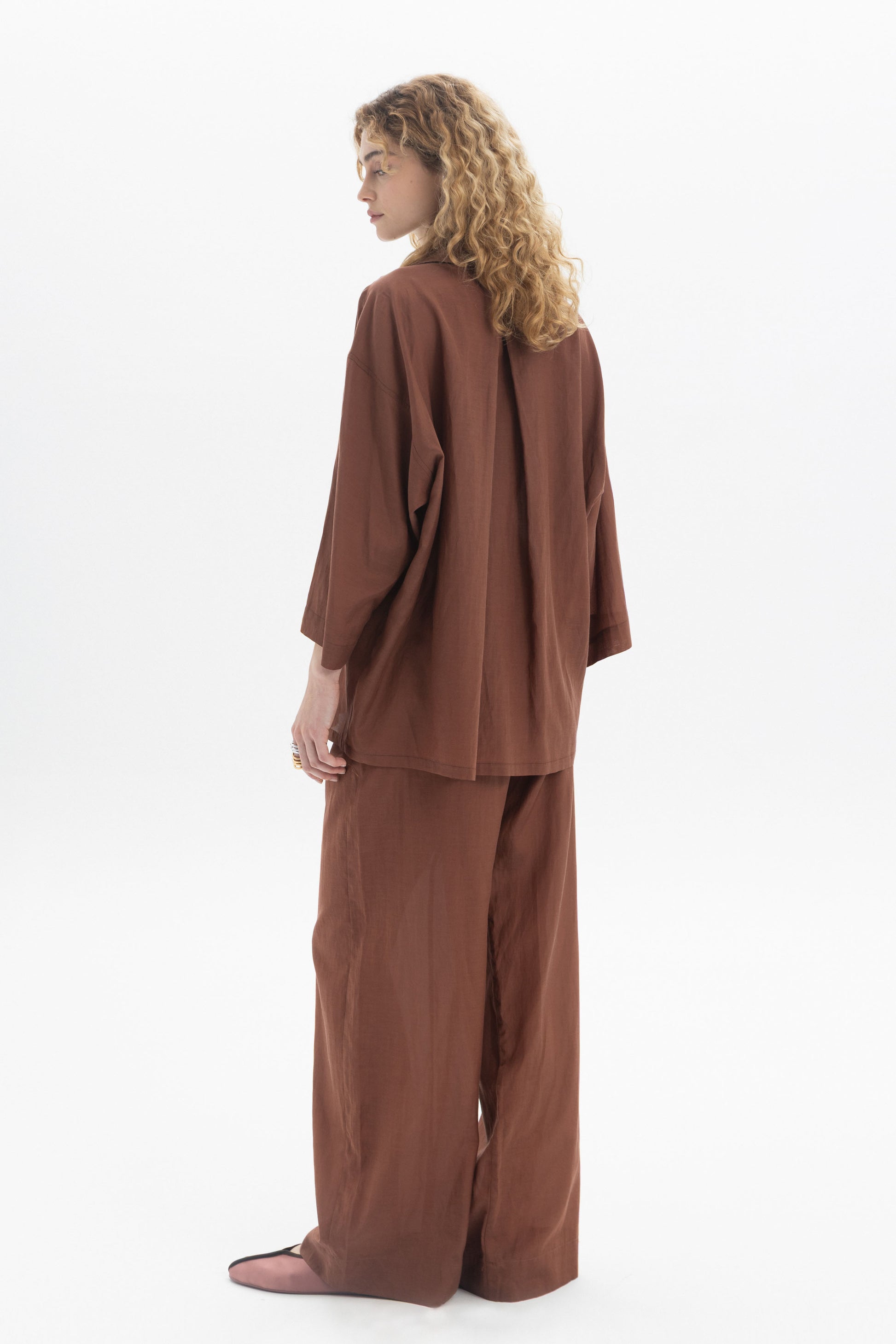Relaxed Button-Up Shirt worn by a model with curly hair, showcasing the relaxed silhouette and soft fabric.