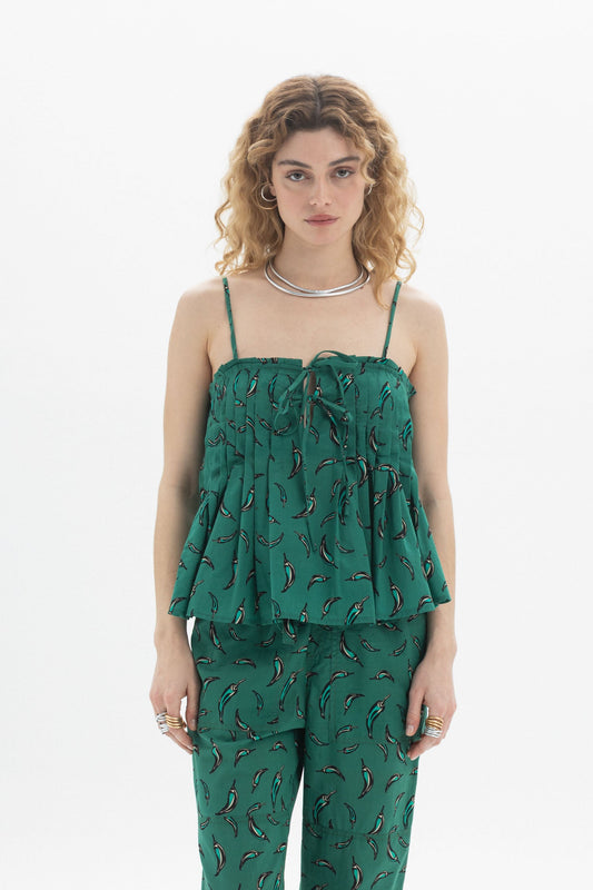 Woman wearing a Tie Front Cami with gathered neckline and green chili pepper print, paired with matching pants.