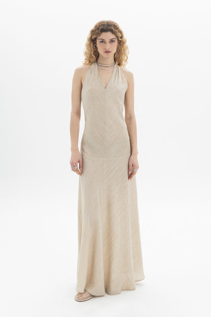 Model wearing a Halter Maxi Dress with a slim fit and open back, styled with accessories.