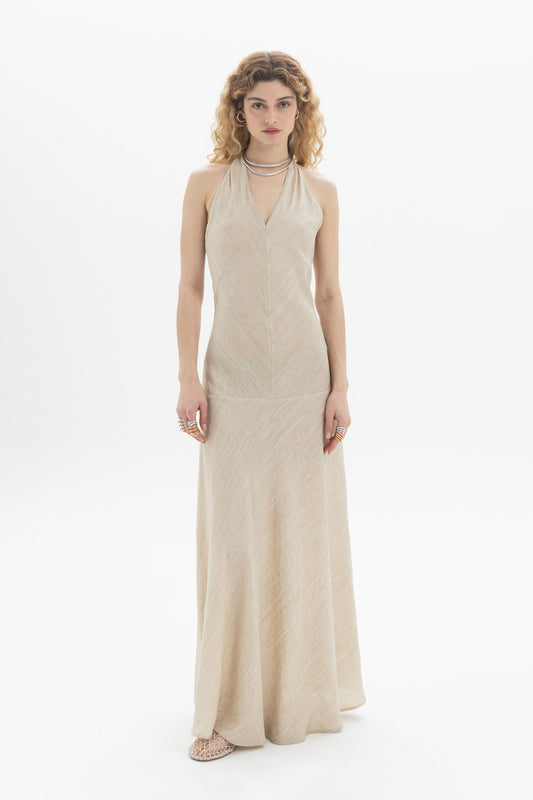 Model wearing a Halter Maxi Dress with a slim fit and open back, styled with accessories.