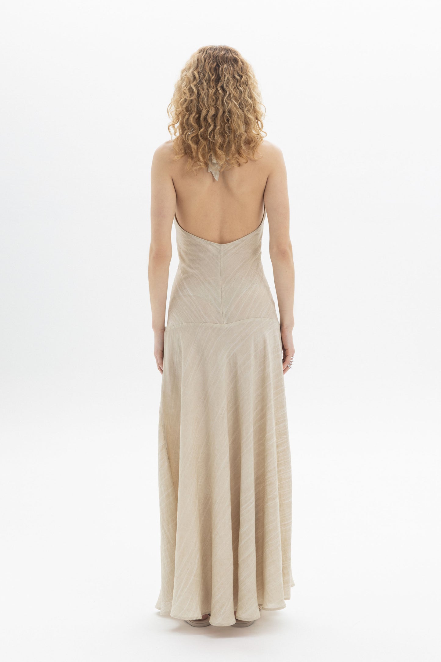 Halter Maxi Dress viewed from the back, showcasing the fluid skirt and open back design.