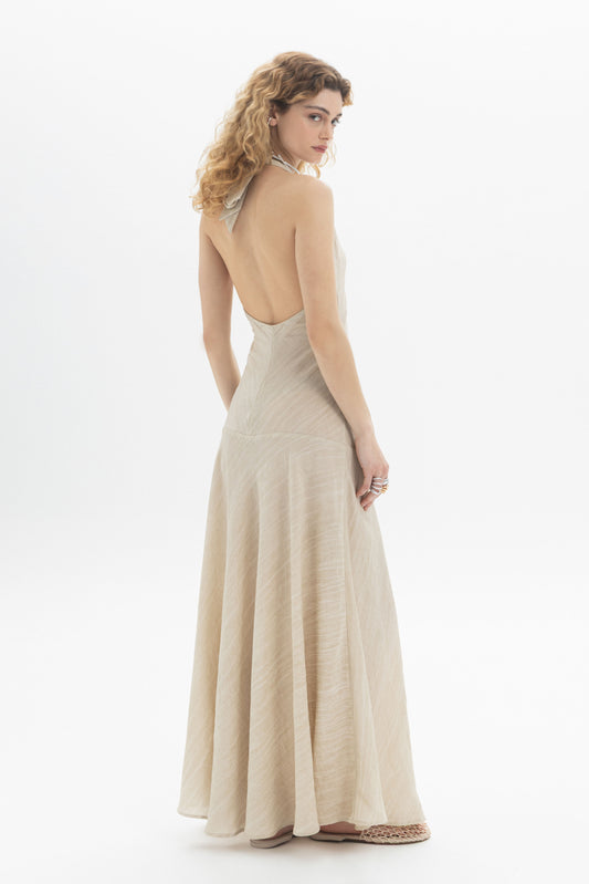 Halter Maxi Dress showcasing a slim fit bodice and fluid flared skirt, featuring a halter neckline and open back.