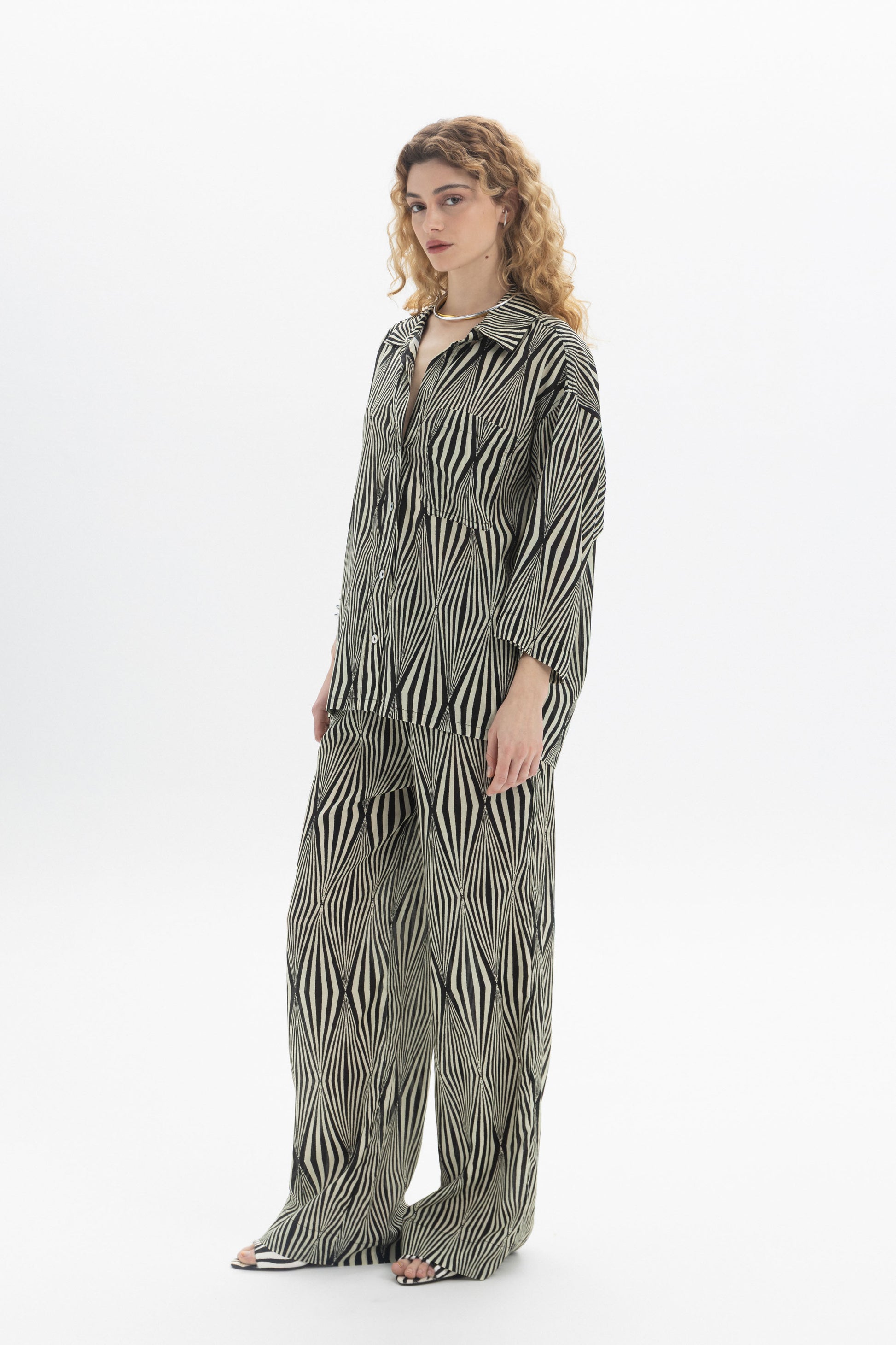 Relaxed Printed Shirt worn by model, featuring a classic collar, button closure, and all-over graphic print.