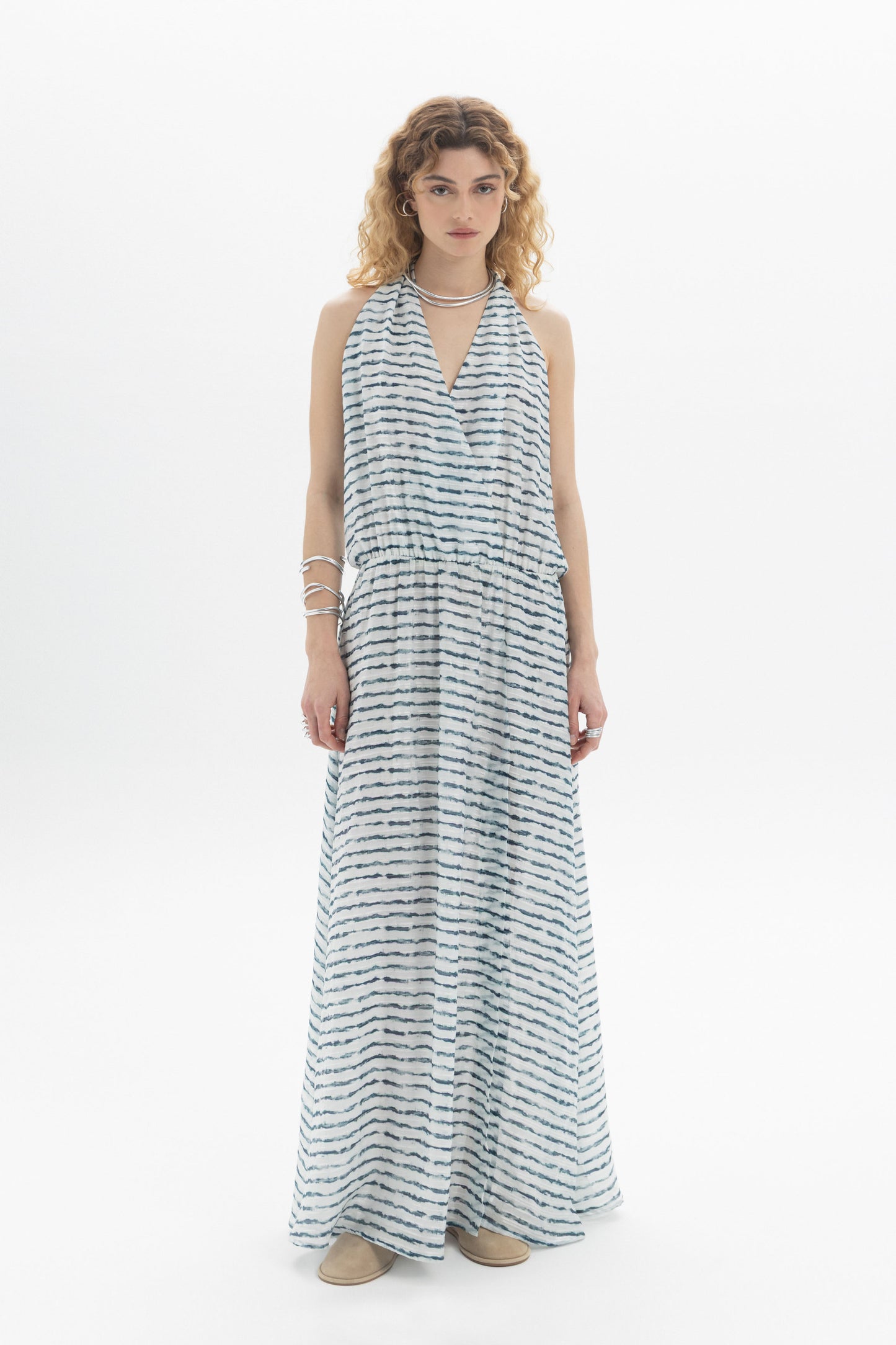 Open-Back Halter Dress featuring a halter neckline and deep open back in a flowing maxi style.