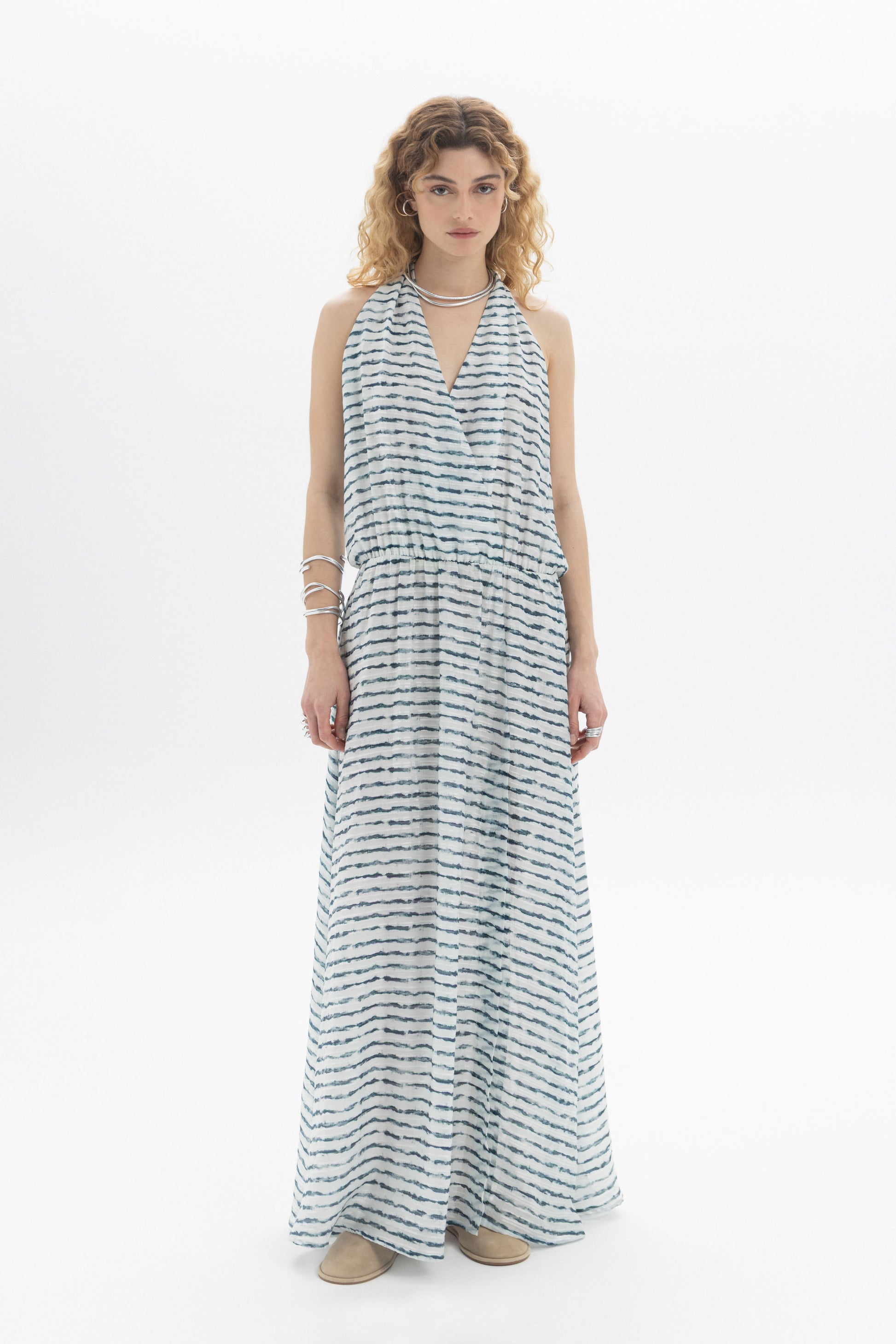 Open-Back Halter Dress featuring a halter neckline and deep open back in a flowing maxi style.