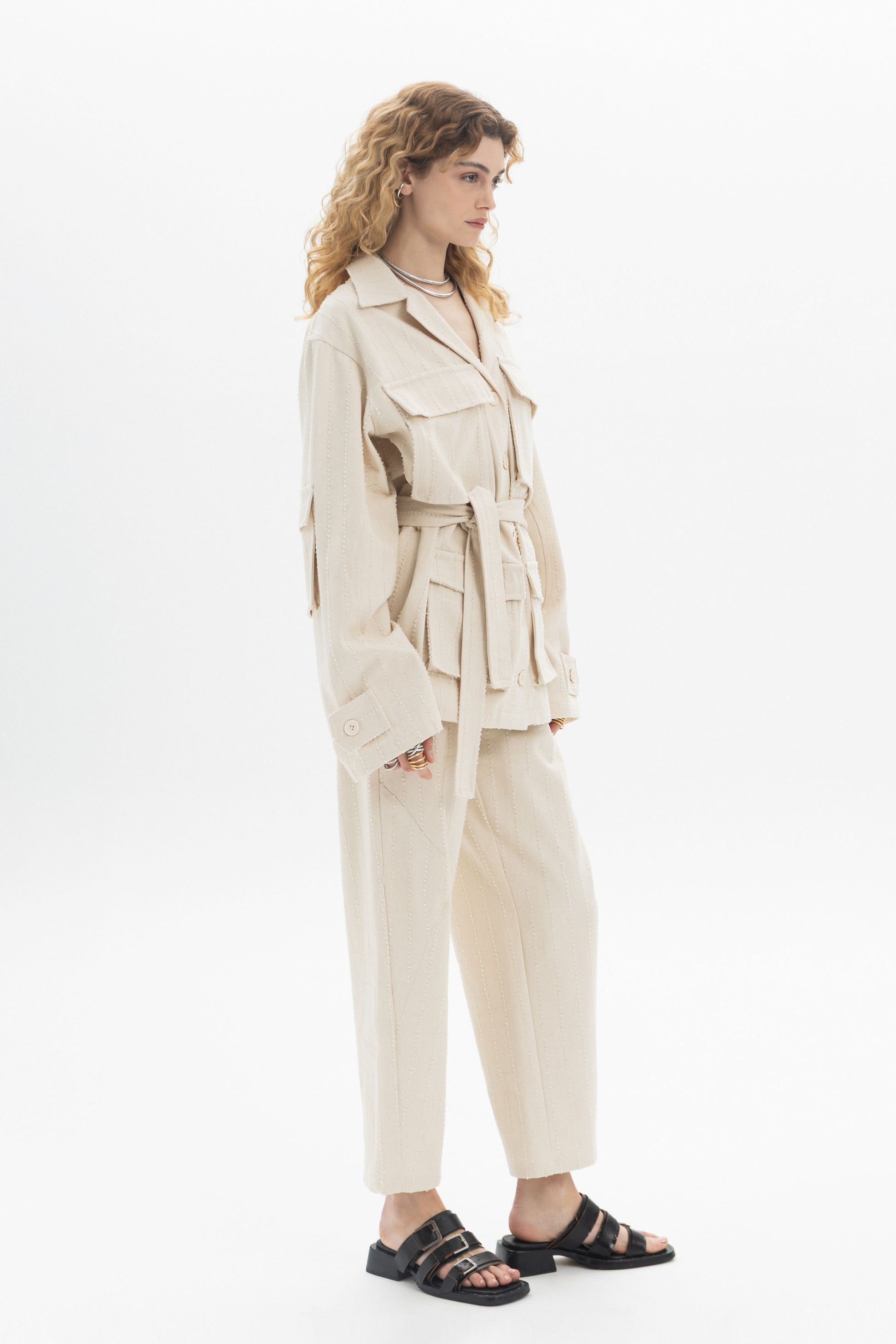 Belted Denim Utility Jacket styled with multiple flap pockets and a self-tie belt worn over relaxed-fit pants.
