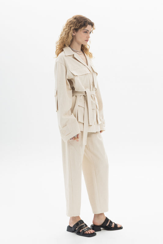 Belted Denim Utility Jacket styled with multiple flap pockets and a self-tie belt worn over relaxed-fit pants.