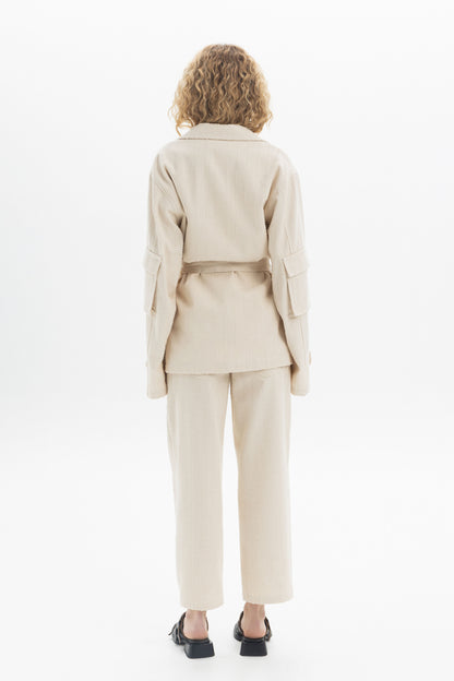 Back view of a model wearing a Belted Denim Utility Jacket with structured collar and multiple pockets.