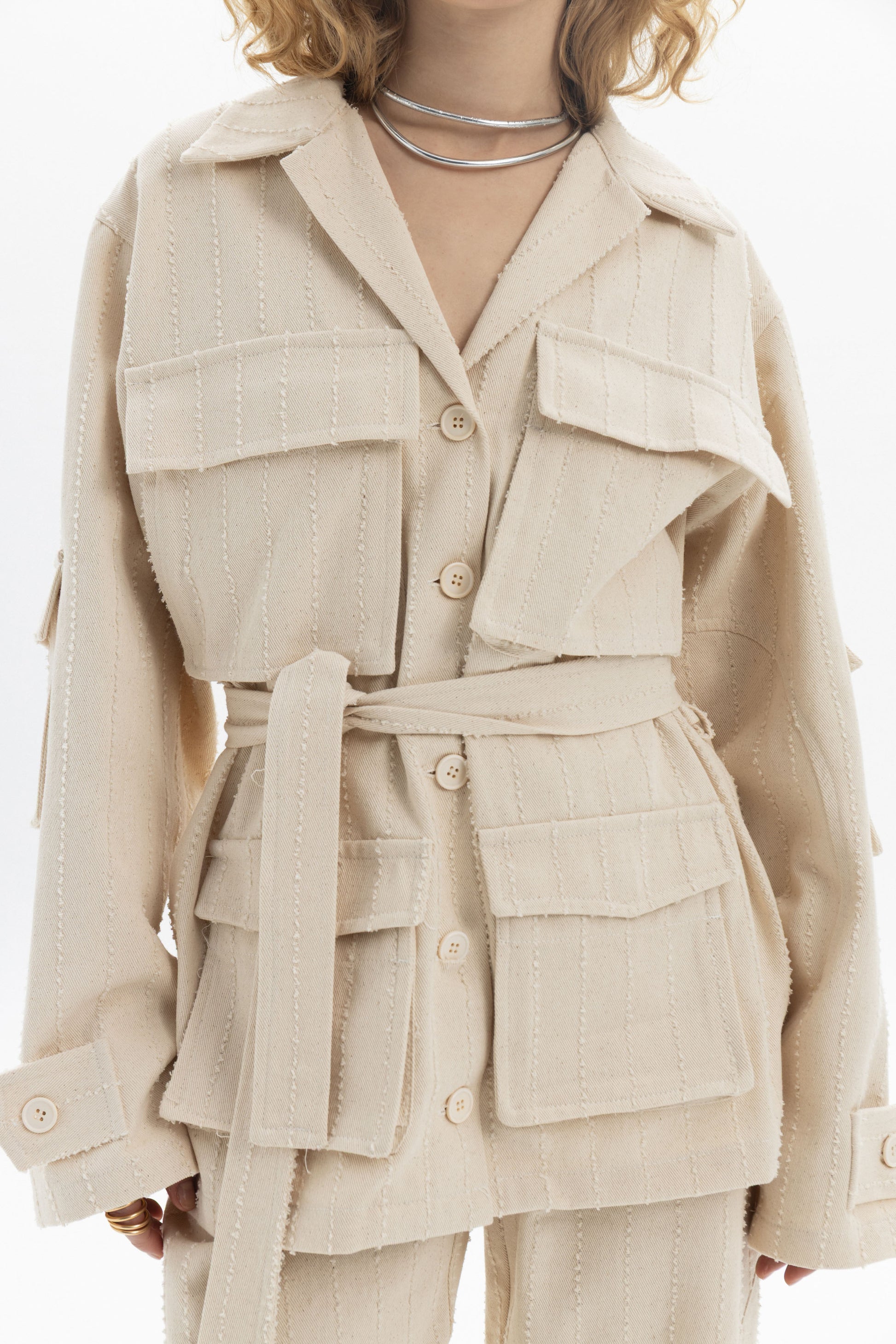 Belted Denim Utility Jacket featuring a relaxed fit, structured collar, flap pockets, and self-tie belt.
