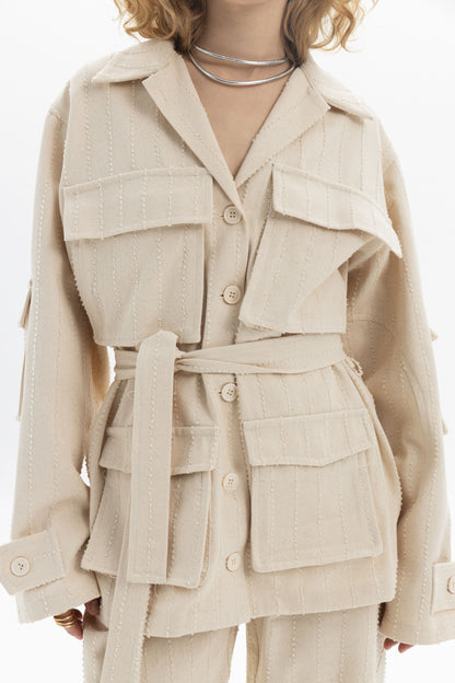Belted Denim Utility Jacket featuring a relaxed fit, structured collar, flap pockets, and self-tie belt.