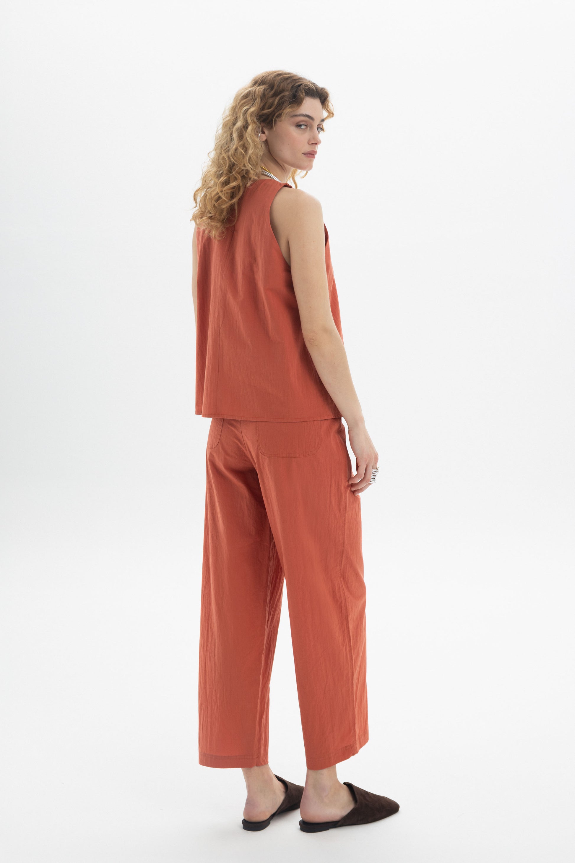 Model showcasing a terracotta Halter Cotton Top with relaxed fit, paired with matching pants for a stylish summer look.