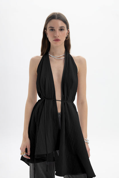 Model wearing a Longline Halter Top featuring a deep neckline and draped panels for elegant movement.