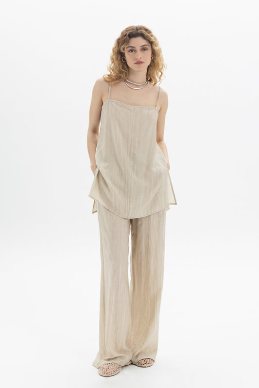 Fluid Cami longline camisole in beige with relaxed silhouette and side slits, paired with matching pants.