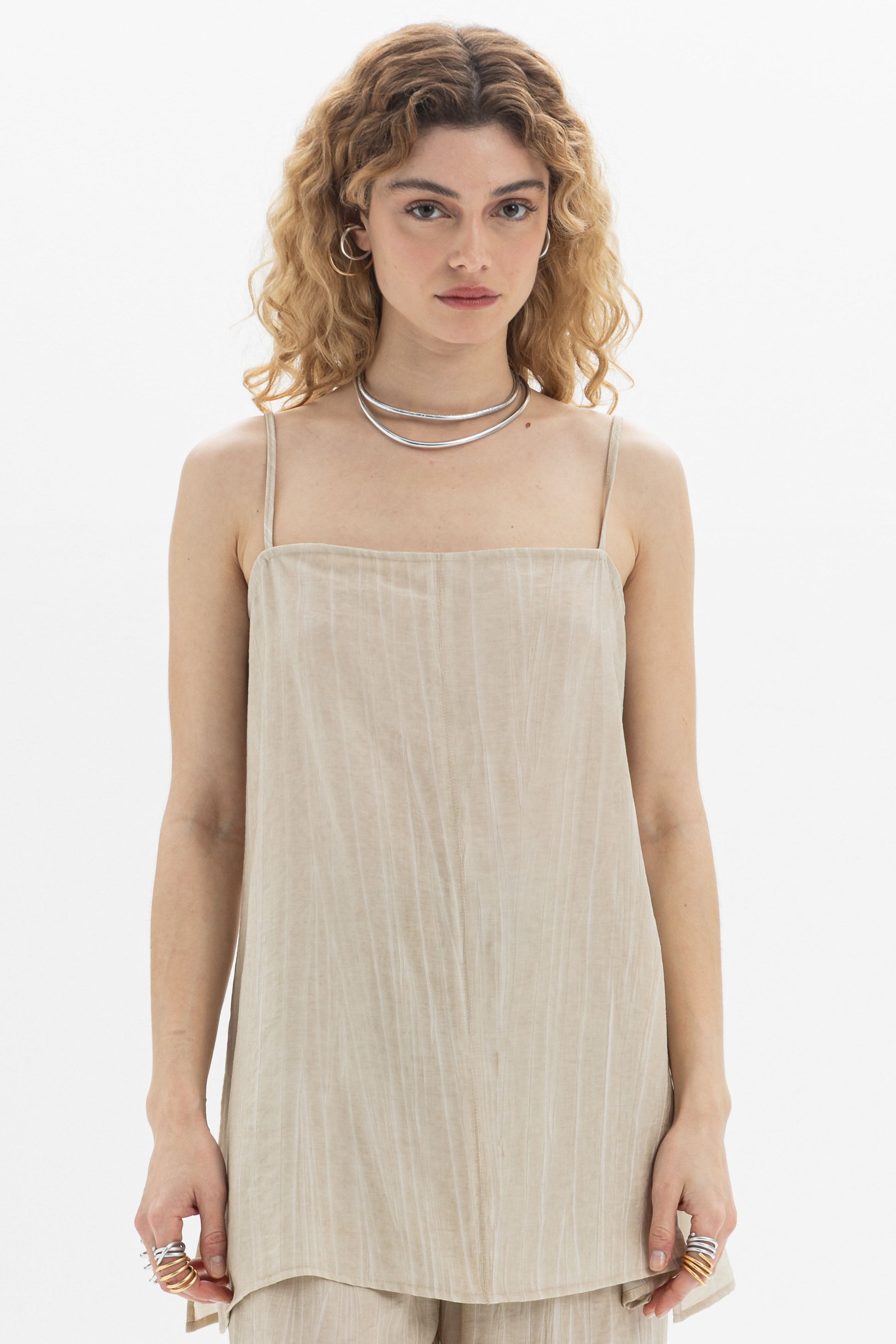 Fluid Cami featuring a longline design, relaxed silhouette, slim straps, and elegant side slits for movement.
