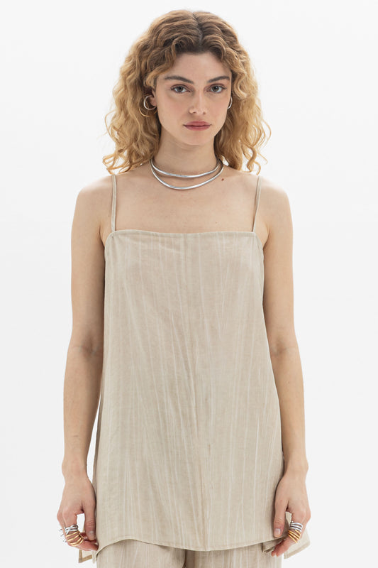 Fluid Cami featuring a longline design, relaxed silhouette, slim straps, and elegant side slits for movement.