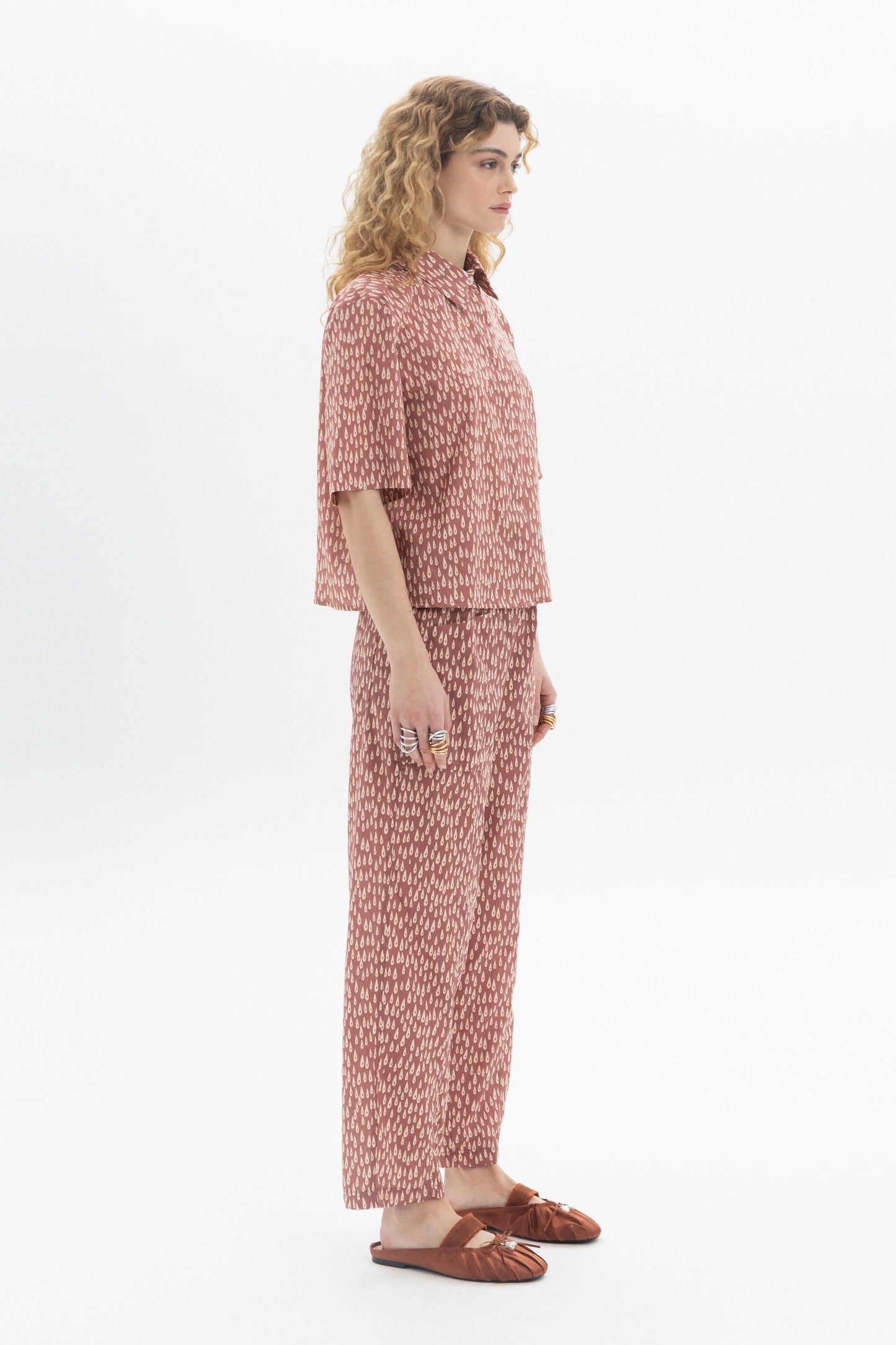 Model wearing a Short Sleeve Shirt with abstract print, styled with matching pants for a modern look.